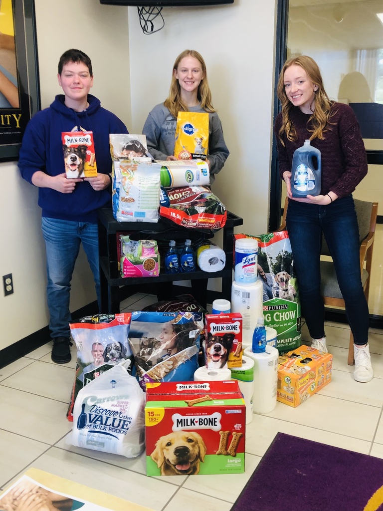 Girls and boy pose with pet food donations